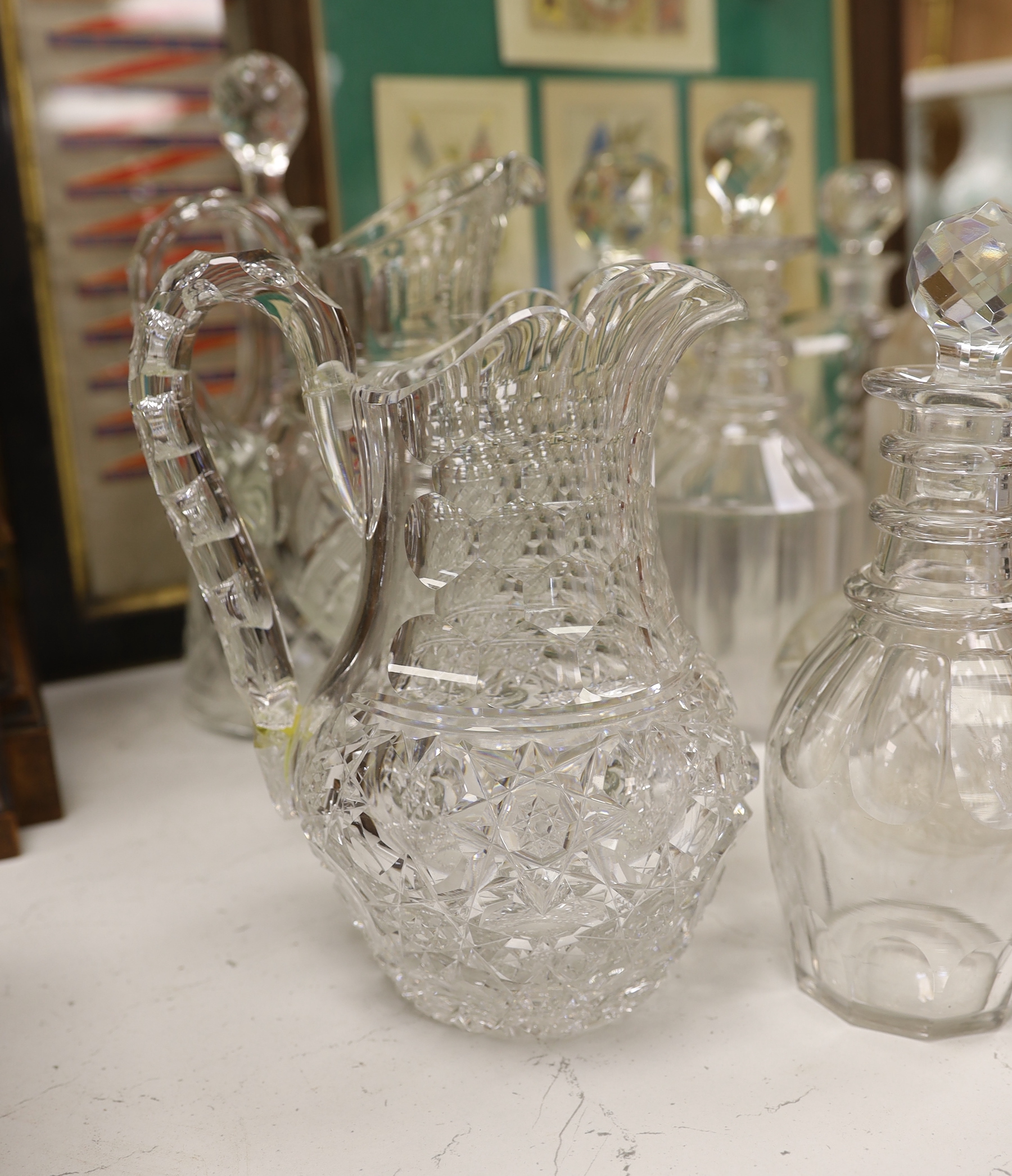 A quantity of cut glass decanters and jugs